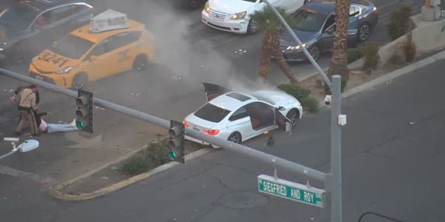 The Las Vegas police officer and passerby were credited with saving the driver's life