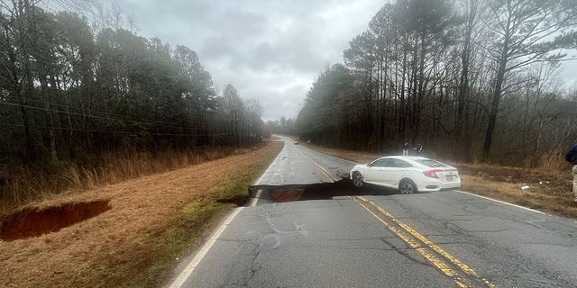 Athens-Clarke County police captured the moment a white sedan fell into a gap in the road.