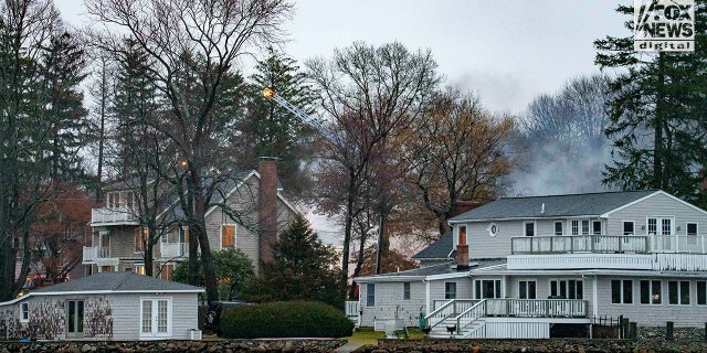 Firefighters battle a blaze at 725 Jerusalem Road in Cohasset, MA on Friday, January 7, 2023. The home once belonged to Ana Walshe who has been reported missing, last seen on New Year's Day.