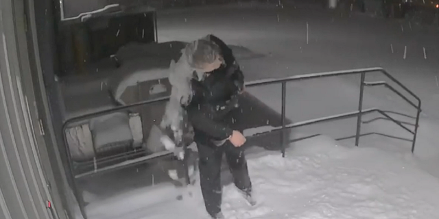 Jamieson then shakes off the snow before walking away from the Viroqua Police Department building.