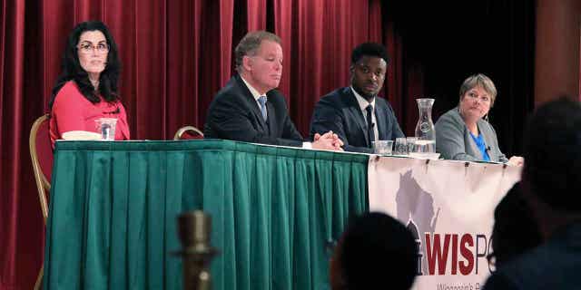 Wisconsin Supreme Court candidates Janet Protasiewicz (right) and Dan Kelly (second from left) will participate in a televised debate on March 21.