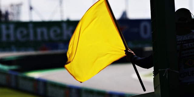A yellow flag is waved.