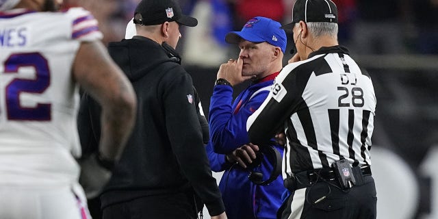 Head coach Sean McDermott of the Buffalo Bills and head coach Zac Taylor of the Cincinnati Bengals speak during the suspension of their game following the injury to Buffalo Bills' Damar Hamlin #3 at Paycor Stadium January 2, 2023 in Cincinnati, Ohio.