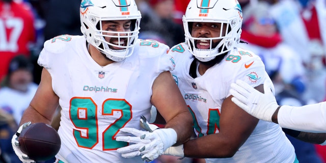 Zach Sieler #92 of the Miami Dolphins celebrates after scoring a touchdown against the Buffalo Bills during the third quarter of the AFC Wild Card playoff game at Highmark Stadium on January 15, 2023 in Orchard Park, New York.