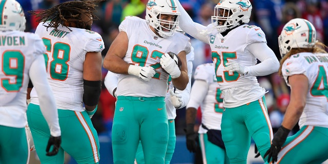 Miami Dolphins defensive tackle Zach Sieler (92) celebrates with teammates after his touchdown during the second half of an NFL wild-card playoff football game against the Buffalo Bills, Sunday, Jan. 15, 2023, in Orchard Park, New York.