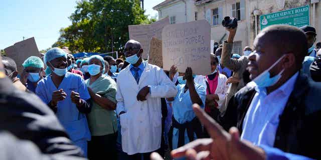Health workers take part in a demonstration over low salaries at Parirenyatwa Hospital in Harare on June 21, 2022. Zimbabwe has decreed a law that bans health workers such as nurses and doctors from prolonged strikes.