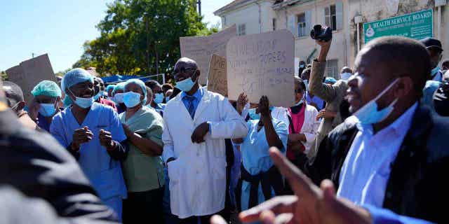 Health workers take part in a demonstration over low salaries at Parirenyatwa Hospital in Harare on June 21, 2022. Zimbabwe has decreed a law that bans health workers such as nurses and doctors from prolonged strikes.
