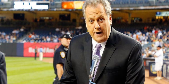 New York Yankees broadcaster Michael Kay participates during pregame ceremonies prior to a game against the San Francisco Giants at Yankee Stadium Sept. 20, 2013, in the Bronx borough of New York City.