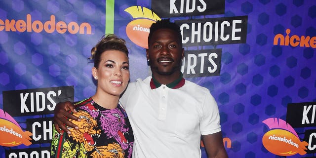 Chelsie Kyriss (L) and NFL player Antonio Brown pose backstage at the Nickelodeon Kids' Choice Sports 2018 at Barker Hangar on July 19, 2018 in Santa Monica, California.