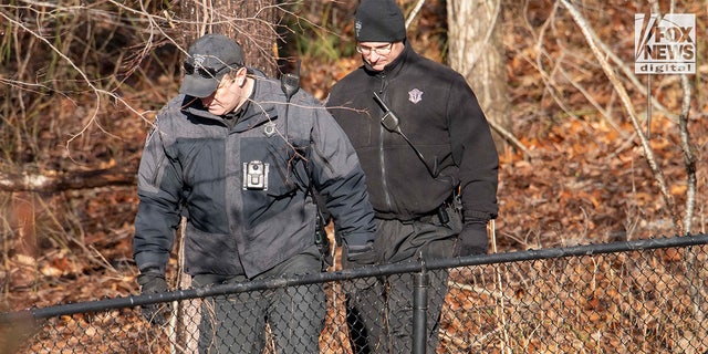 Police officers search the property of Anna Walsh in Cohasset, Massachusetts, Saturday, Jan. 7, 2023.