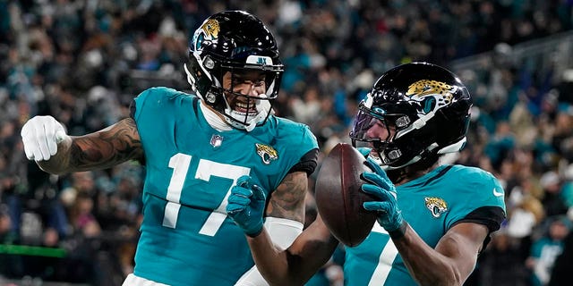 Jacksonville Jaguars wide receiver Zay Jones (7) celebrates his touchdown with tight end Evan Engram (17) during the second NFL wild card game against the Los Angeles Chargers on Saturday, January 14, 2023. , in Jacksonville, Florida. 