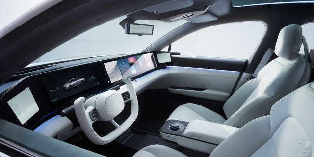 The interior of the Afeela has a widescreen digital display and side video mirrors.