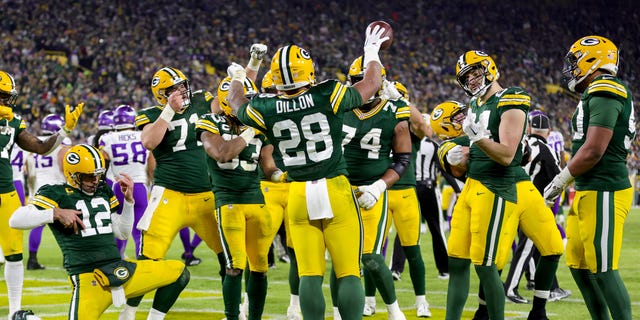 AJ Dillon #28 of the Green Bay Packers celebrates with teammates after running for a touchdown against the Minnesota Vikings during the fourth quarter of the game at Lambeau Field on January 1, 2023 in Green Bay, Wisconsin.