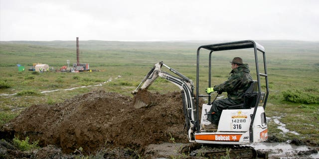 A worker with the Pebble Mine project digs in the Bristol Bay region of Alaska near the village of Iliamma on July 13, 2007. The Bristol Bay region is coveted by mining interests.
