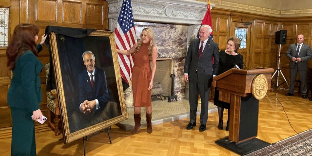 Arkansas Gov. Asa Hutchinson and first lady Susan Hutchinson look on as their granddaughter, Jaella Wengel, left, and daughter, Sarah Wengel, center, unveil the governor’s official portrait on Tuesday, Jan. 3, 2023, at the state Capitol in Little Rock, Ark. Hutchinson will leave office on Jan. 10 after serving eight years as governor. (AP Photo/Andrew DeMillo)