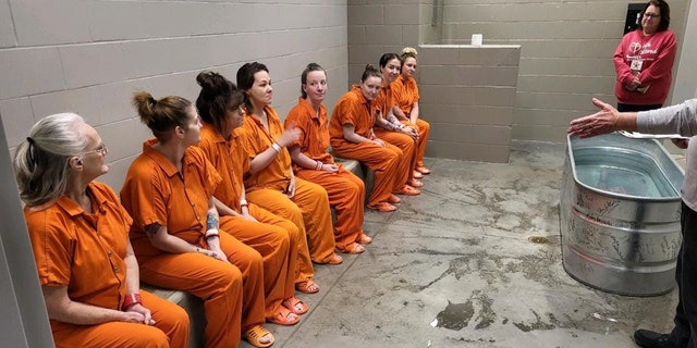 Female inmates await baptism at the Decatur County Jail on Dec. 29, 2022.