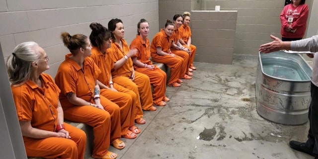 Female inmates await baptism at the Decatur County Jail on Dec. 29, 2022.