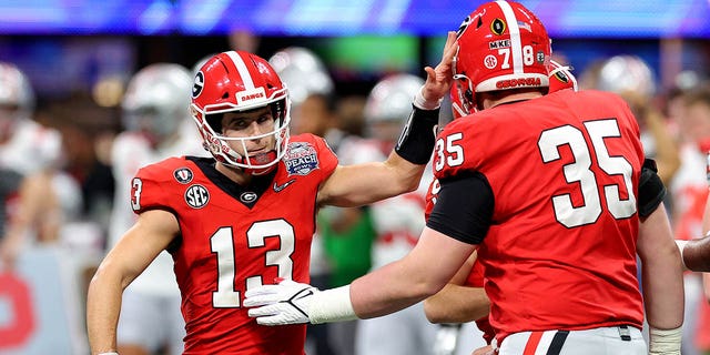 Stetson Bennett #13 of the Georgia Bulldogs reacts after a field goal during the first half against the Ohio State Buckeyes in the Chick-fil-A Peach Bowl at Mercedes-Benz Stadium on December 31, 2022 in Atlanta, Georgia. 