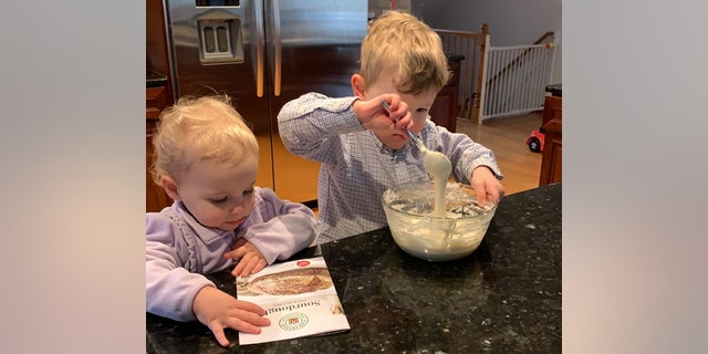 Chicago mom Beverly watches as her children make their own sourdough bread at home.