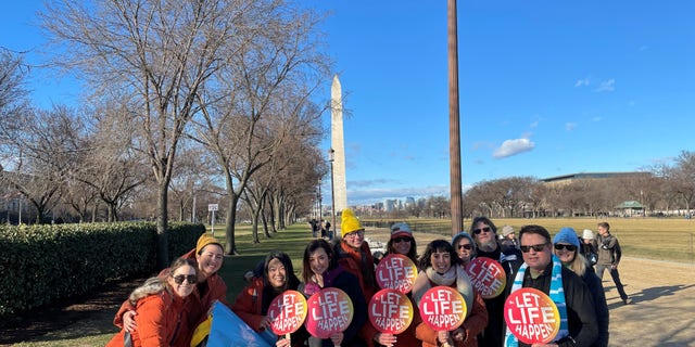 Actress Ashely Bratcher poses with members of Save the Storks at the 50th annual March for Life in Washington, D.C.