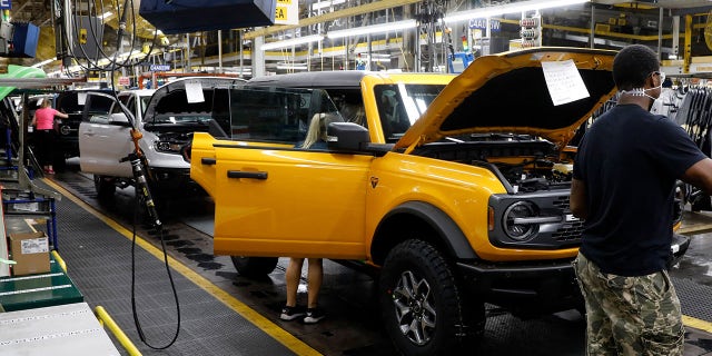 Line workers assemble Ford Motor Company's 2021 Ford Bronco on the production line at their Michigan Assembly Plant in Wayne, Michigan, on June 14, 2021.