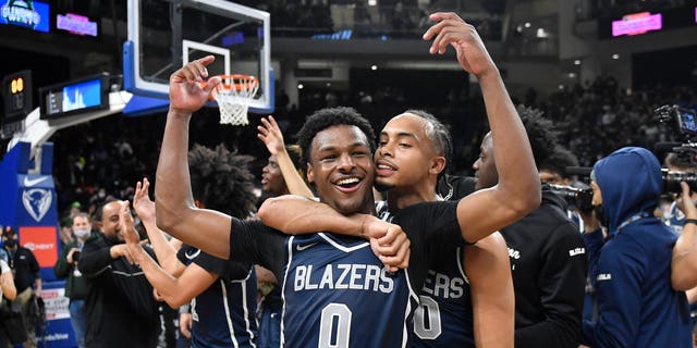 Bronny James #0 and Amari Bailey #10 of Sierra Canyon (CA) celebrate after defeating Glenbard West (IL) at Wintrust Arena on February 5, 2022 in Chicago, Illinois.