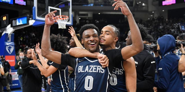 Bronny James #0 and Amari Bailey #10 of Sierra Canyon (CA) celebrate after defeating Glenbard West (IL) at Wintrust Arena on February 5, 2022 in Chicago, Illinois.