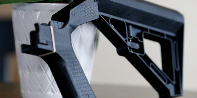 FILE - A bump stock is displayed on March 15, 2019, in Harrisonburg, Virginia.