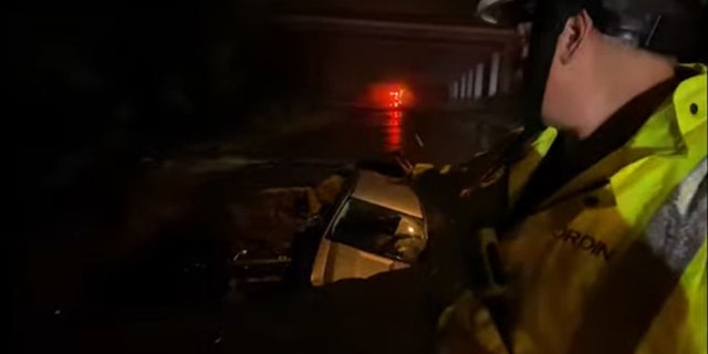 LAFD Battalion Chief Andrew Wordin said that water flowing down the street was filling the growing sinkhole and firefighters had to act quickly to save the two victims.