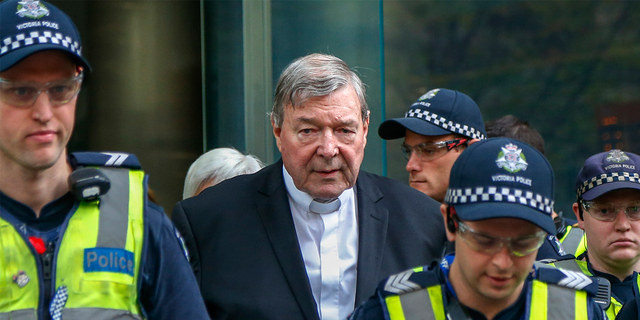 Cardinal George Pell, center, the most senior Catholic cleric to face sex charges, leaves court in Melbourne, Australia, May 2, 2018.