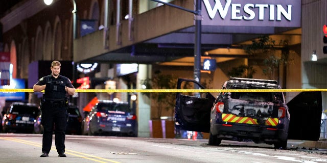 A police officer blocks a downtown street following a protest, Saturday, Jan. 21, 2023, in Atlanta, in the wake of the death of an environmental activist killed after authorities said the 26-year-old shot a state trooper. 