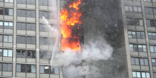 Two workers tasked with restoring a Chicago high-rise damaged in a fire are accused of stealing $19,000 and jewelry from an apartment in the building.
