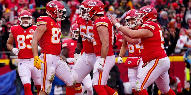 Travis Kelce (87) of the Kansas City Chiefs celebrates with his teammates after scoring an 8-yard touchdown against the Jacksonville Jaguars during the first quarter in an AFC divisional playoff game at Arrowhead Stadium Jan. 21, 2023, in Kansas City, Mo.