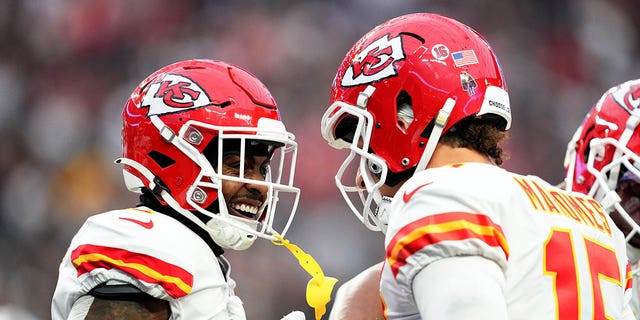 Jerick McKinnon, left, and Patrick Mahomes (15) of the Kansas City Chiefs celebrate after a touchdown against the Los Vegas Raiders during the first quarter at Allegiant Stadium on January 7, 2023 in Las Vegas. 