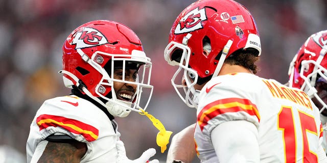 Jerick McKinnon, left, and Patrick Mahomes (15) of the Kansas City Chiefs celebrate after a touchdown against the Los Vegas Raiders during the first quarter at Allegiant Stadium on January 7, 2023 in Las Vegas. 