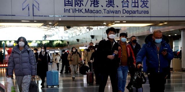 Passengers walk at the Beijing Capital International Airport on Dec. 27, 2022, amid a COVID-19 outbreak in China.