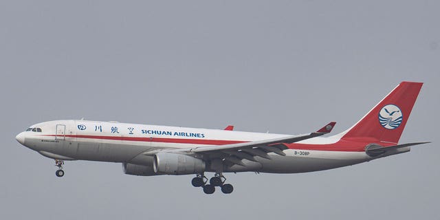 A Sichuan Airlines flight is seen flying before landing in Brussels, Belgium, on Jan. 30, 2022. 