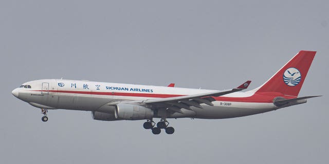 A Sichuan Airlines flight is seen flying before landing in Brussels, Belgium, on Jan. 30, 2022. 