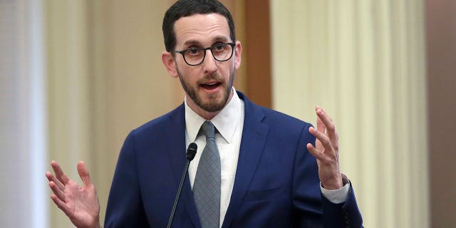State Sen. Scott Weiner talks during a Senate hearing in Sacramento, California, on June 28, 2018. A California climate package was introduced Monday. The bills would require companies to disclose its emissions, create a group to evaluate climate-caused financial risk, and ban public pension funds from investing in major fossil fuel companies.