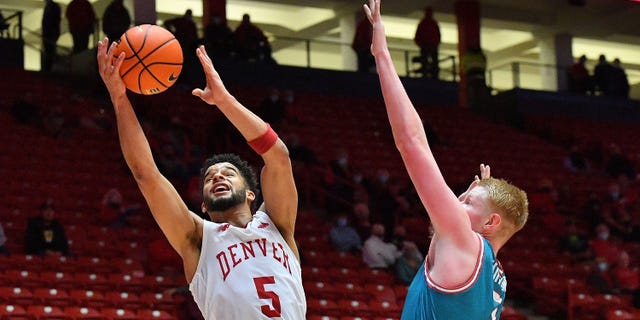 Coban Porter #5 of the Denver Pioneers shoots against Sebastian Forsling of the New Mexico Lobos at The Pit on Dec. 9, 2021, in Albuquerque, New Mexico.