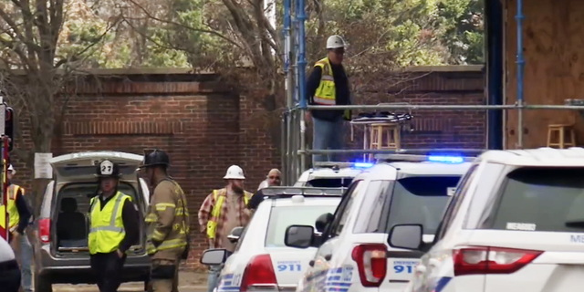 Charlotte police vehicles at the scene of an "industrial accident" after a scaffolding collapse caused casualties at a construction site.