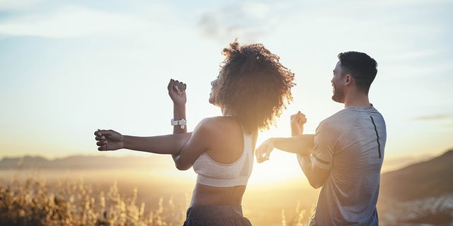 couple stretching health and fitness