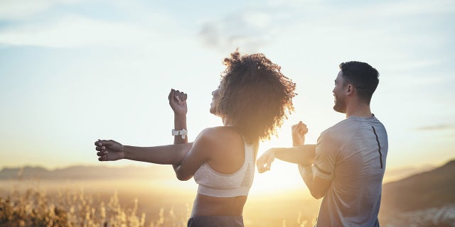couple stretching health and fitness