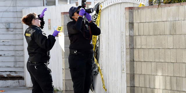 Members of the forensics team gather evidence at the scene of a fatal shooting in Long Beach, California.
