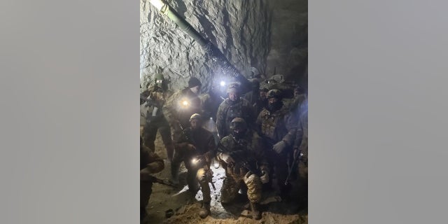 People in uniform, allegedly soldiers of the Russian mercenary group Wagner and its chief Yevgeny Prigozhin, pose for a photo believed to be at a salt mine in Soledar, Donetsk region, Ukraine, in this photo posted Jan. 10, 2023. 