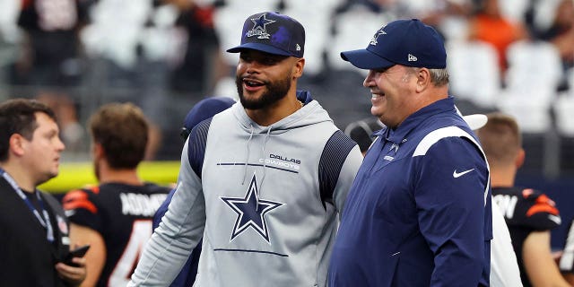 Dak Prescott and head coach Mike McCarthy of the Dallas Cowboys visit during warmups before a game against the Cincinnati Bengals at AT and T Stadium Sept. 18, 2022, in Arlington, Texas.