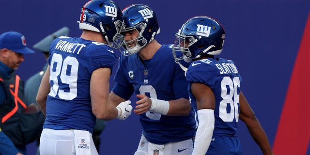 Daniel Jones of the New York Giants is congratulated by teammates after scoring a touchdown against the Indianapolis Colts on January 1, 2023 in East Rutherford, New Jersey.