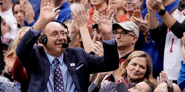 Sportscaster Dick Vitale waves to the crowd as he is honored during a game between the Indiana Hoosiers and the Kansas Jayhawks in the first half at Allen Fieldhouse on December 17, 2022 in Lawrence, Kansas.
