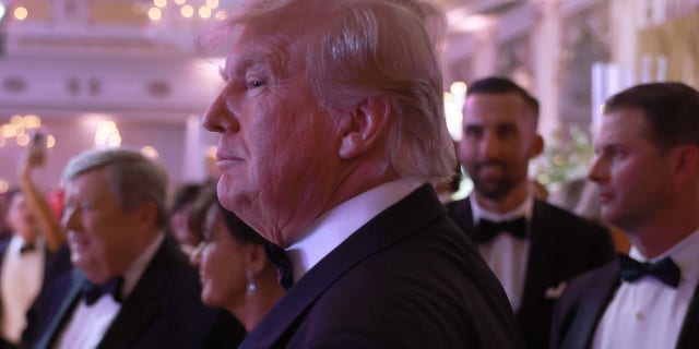 Former President Trump greets people as he arrives for a New Years event at his Mar-a-Lago home on Dec. 31, 2022 in Palm Beach, Florida.