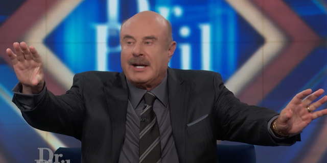 Dr. Phil calms his guests and audience down after fierce debate. 
